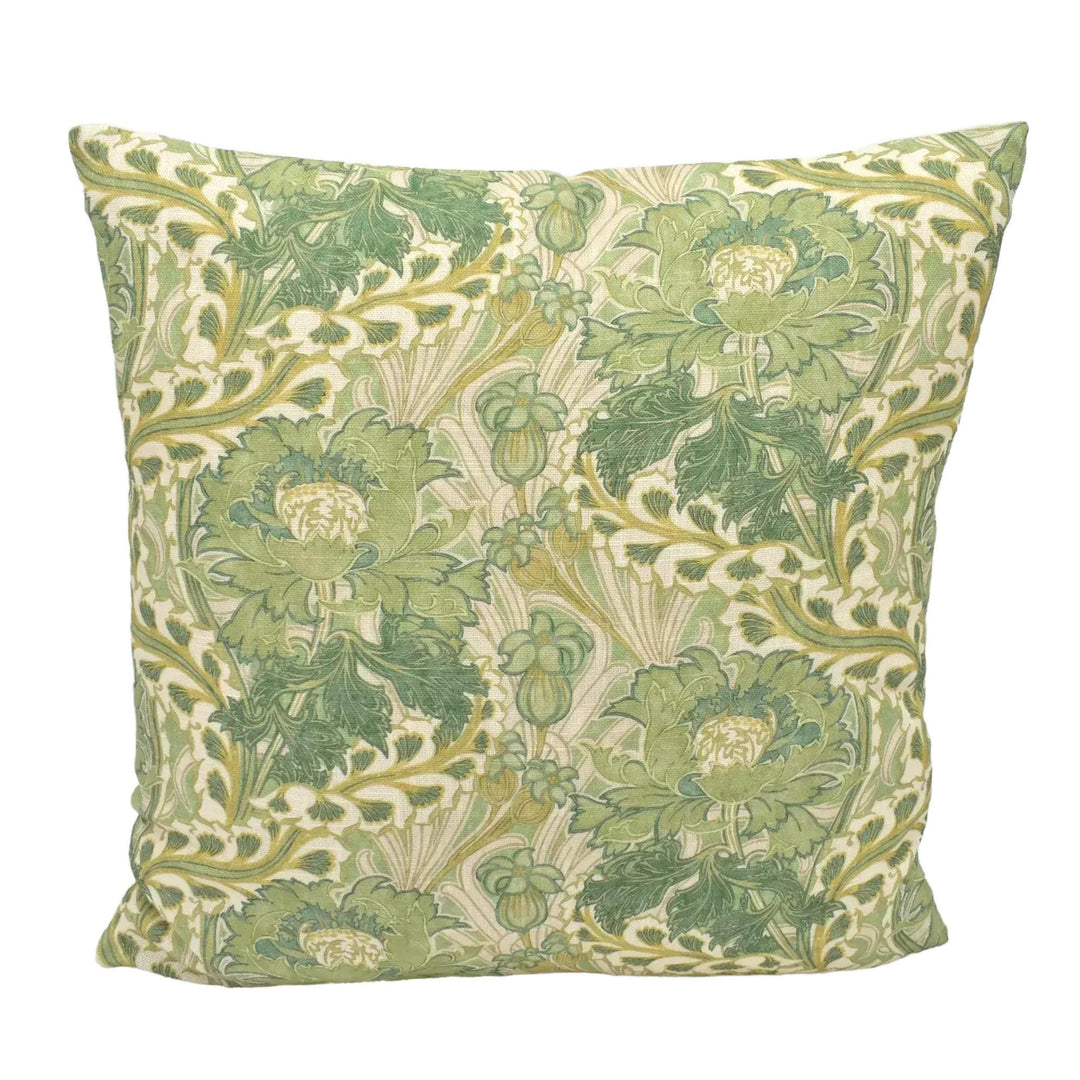A decorative throw pillow with a repeating pattern of green and white flowers and leaves.