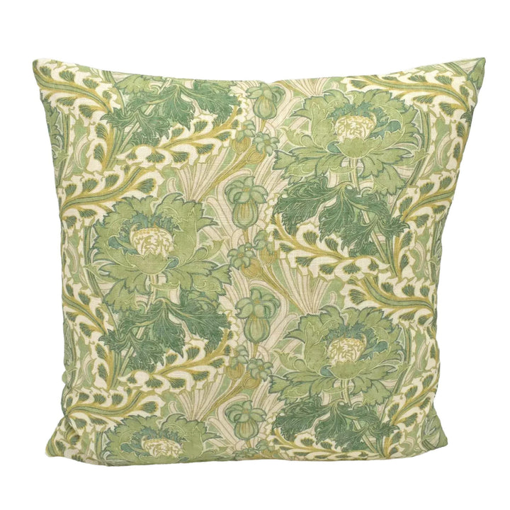 A decorative throw pillow with a repeating pattern of green and white flowers and leaves.