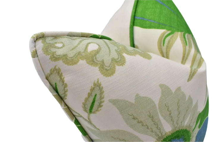 a close-up view of a decorative pillow with a floral pattern in shades of green and white.