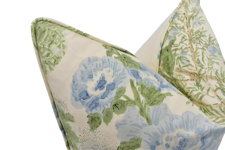two decorative pillows with a floral pattern in shades of green and blue.