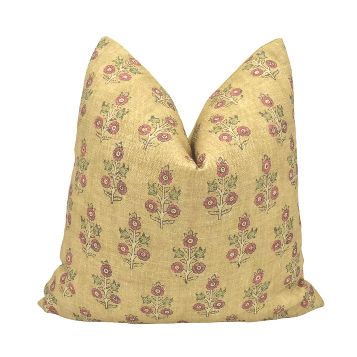 A yellow throw pillow with a floral print pattern is displayed against a white background.