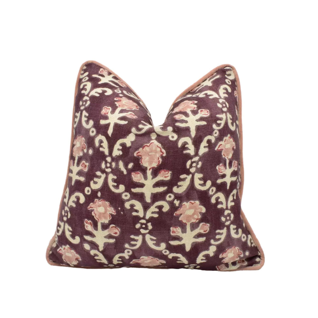 A decorative purple and white patterned pillow with a floral design.