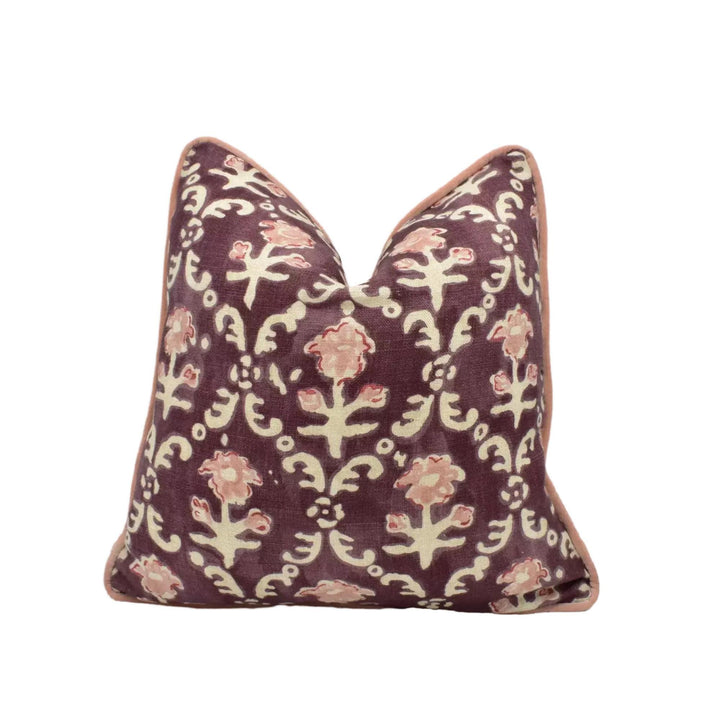 A decorative purple and white patterned pillow with a floral design.