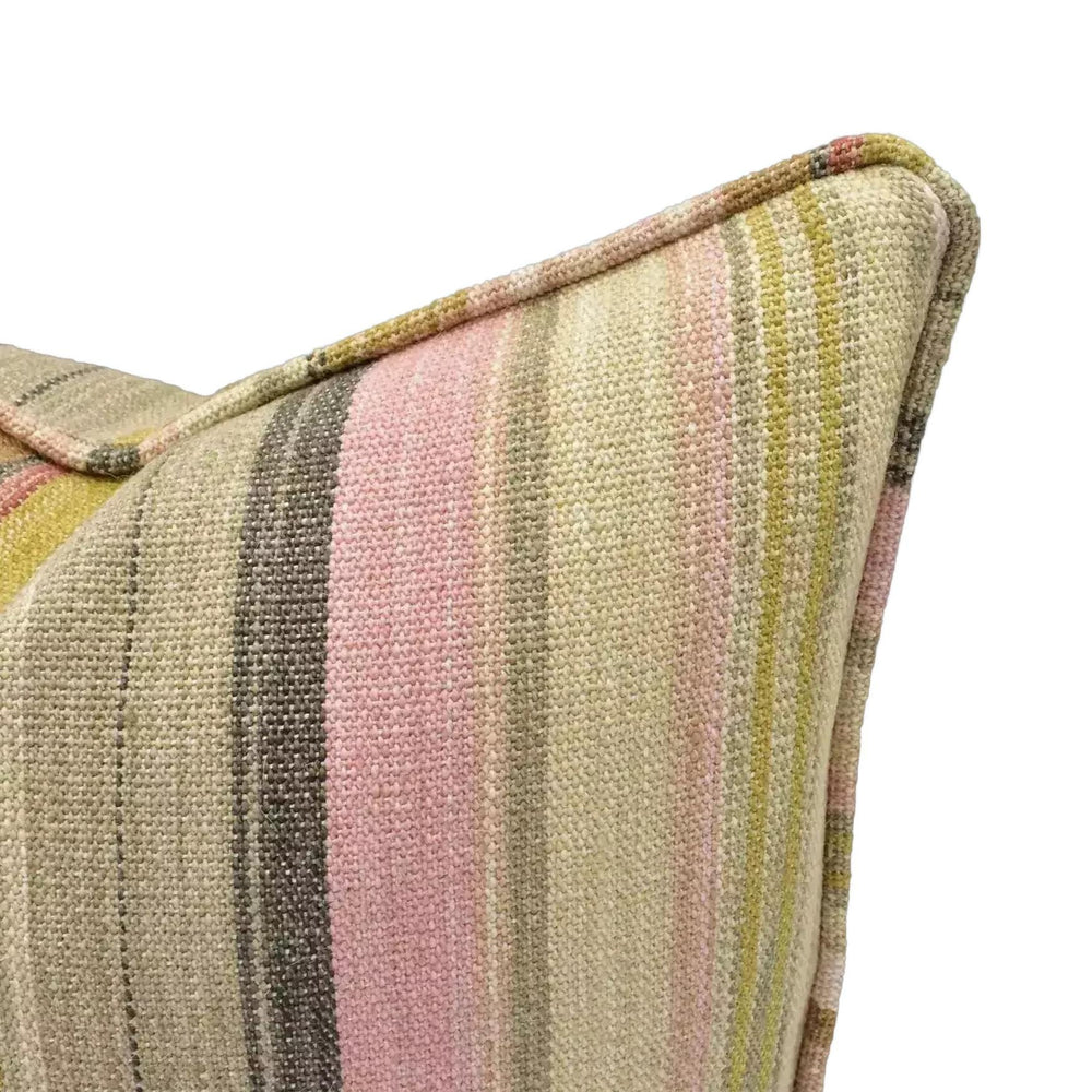 A close-up view of a colorful, striped pillow with a pink and yellow pattern.