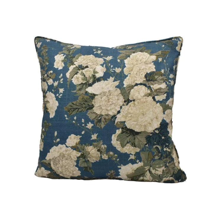 A square throw pillow with a floral print in shades of blue and white.