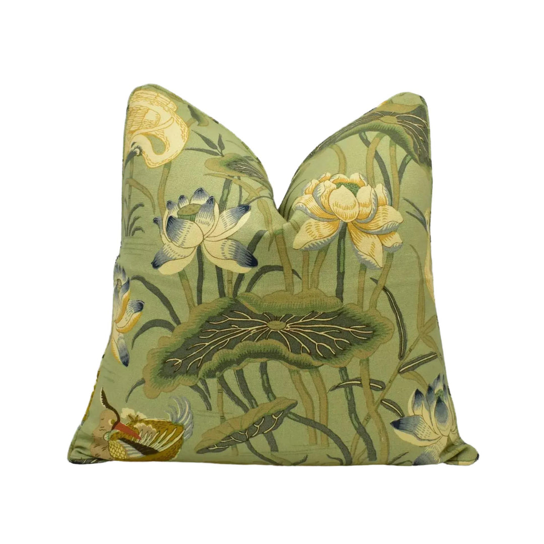a green and yellow floral print pillow with a lotus flower design.