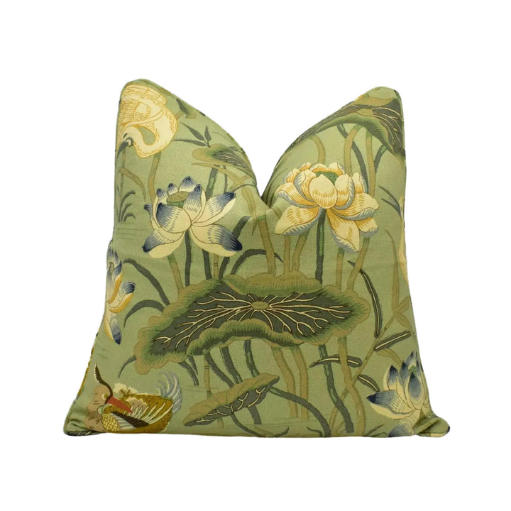 a green and yellow floral print pillow with a lotus flower design.