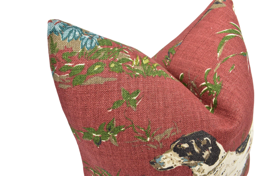a close-up view of a red fabric with a floral pattern, featuring a dog's head and ears.