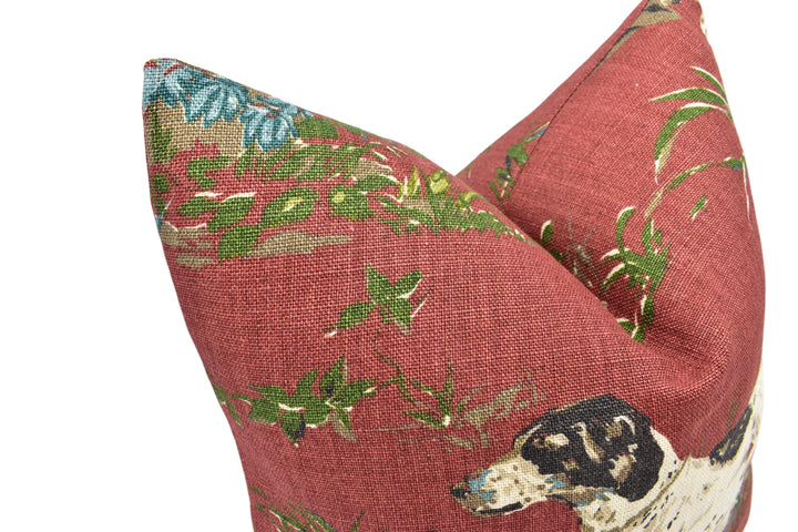 a close-up view of a red fabric with a floral pattern, featuring a dog's head and ears.