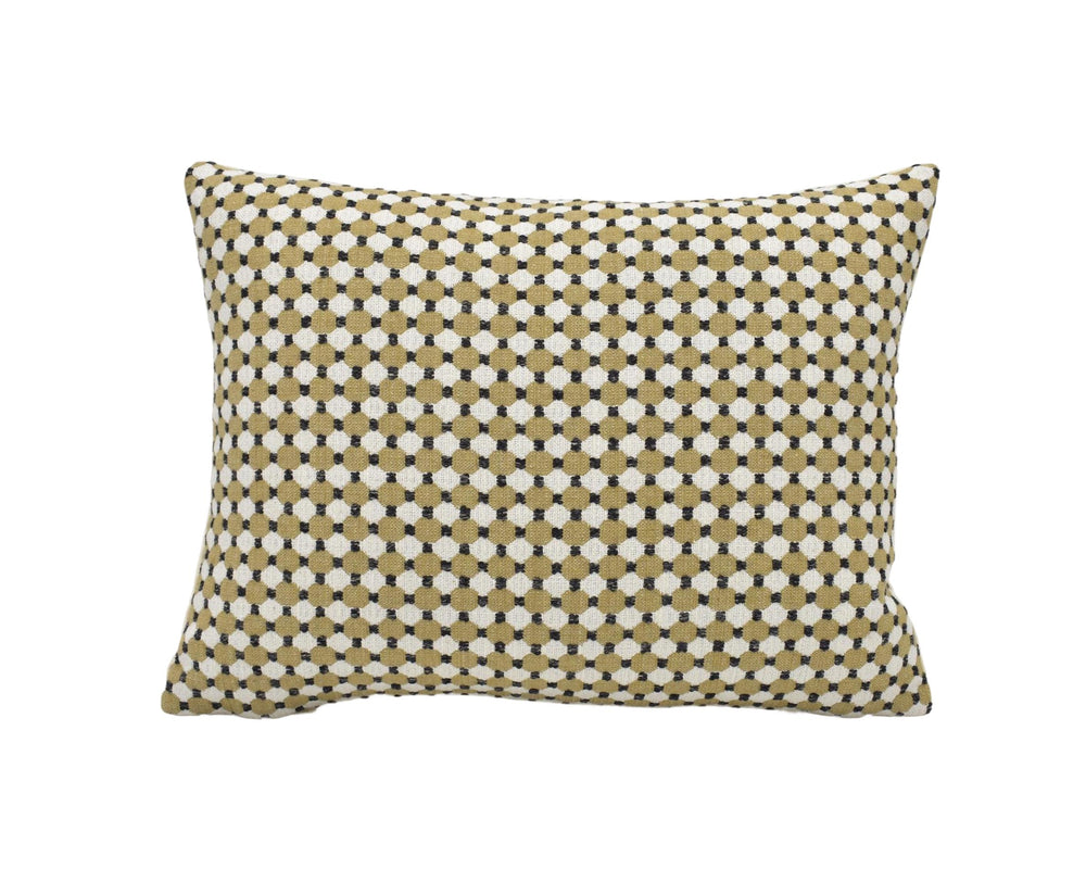 A square throw pillow with a geometric pattern of small white and beige dots.