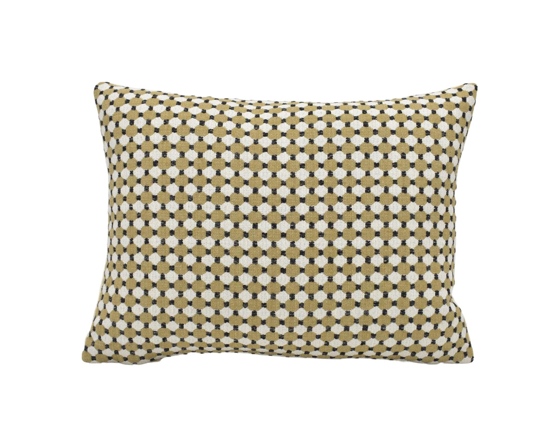A square throw pillow with a geometric pattern of small white and beige dots.
