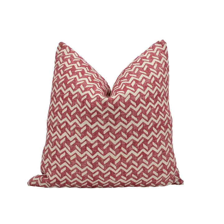 A single pillow with a red and white geometric pattern.