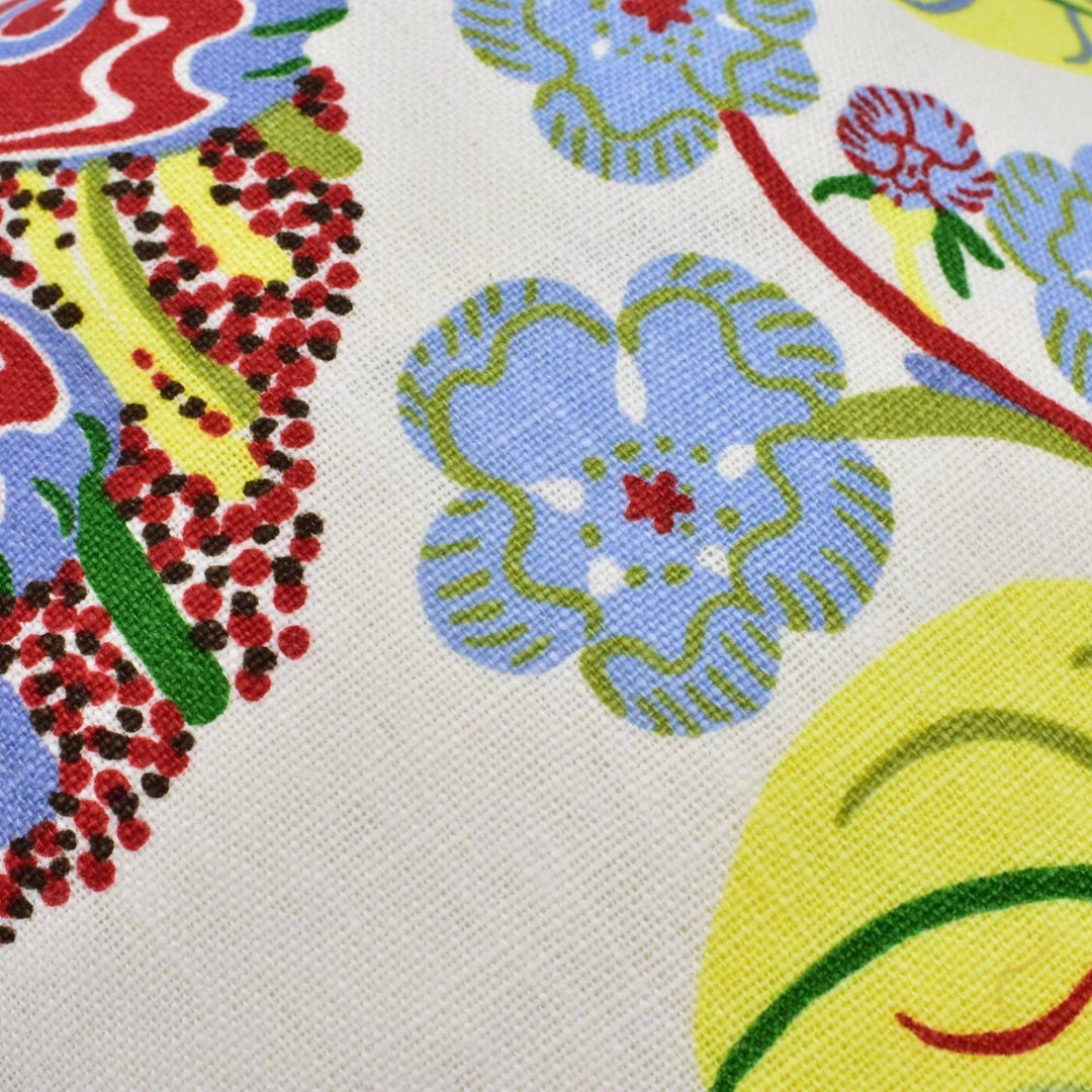 a close-up view of a colorful, patterned fabric with various shapes and designs, including flowers and leaves.