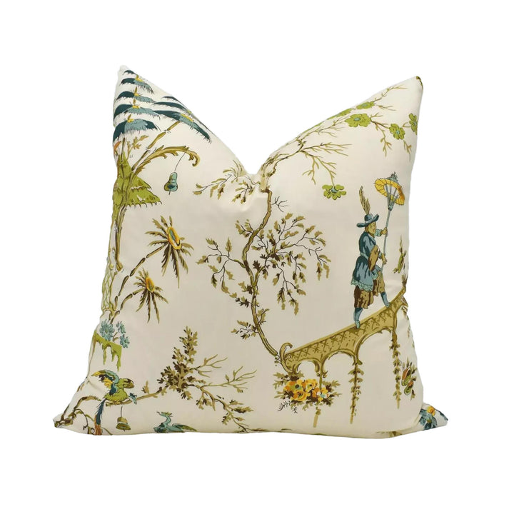 A decorative throw pillow with a floral and bird motif, featuring a mix of green, yellow, and blue colors.