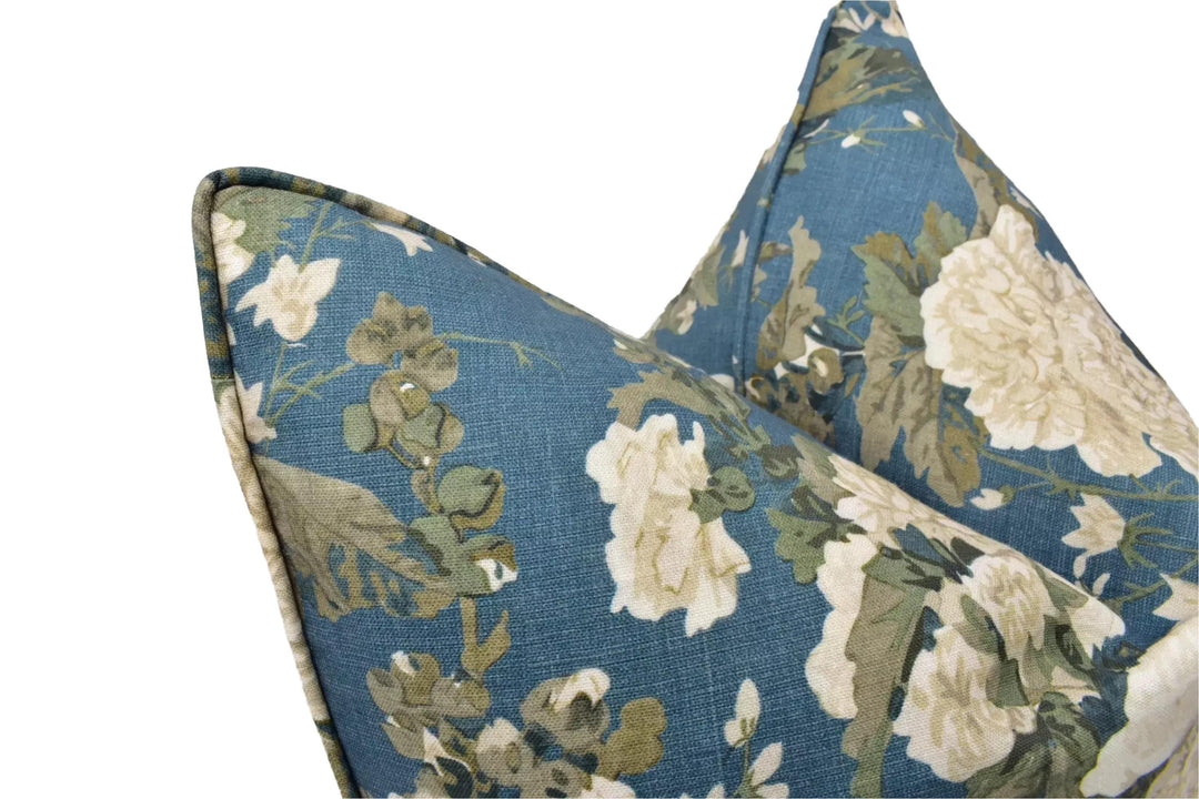 a close-up view of a blue and white floral patterned pillow, with the focus on the intricate details of the design.
