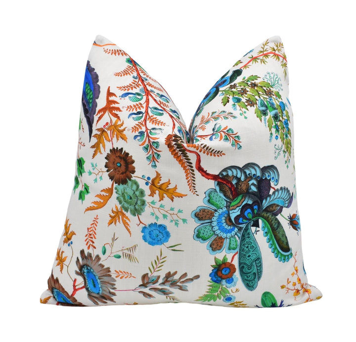 a decorative pillow with a vibrant floral pattern in various colors, including blue, green, orange, and brown.