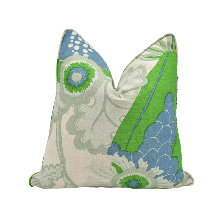 A decorative throw pillow with a floral pattern in shades of green and blue.