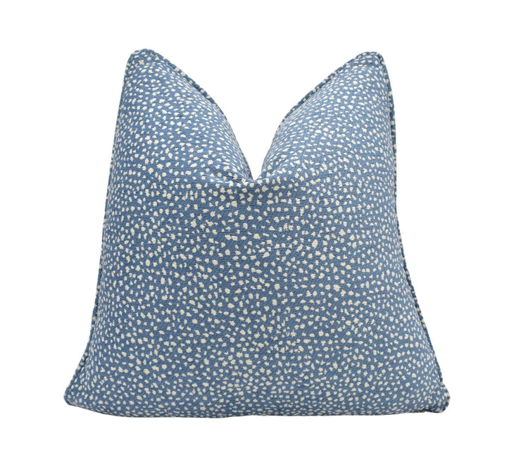 a blue pillow with white dots on it