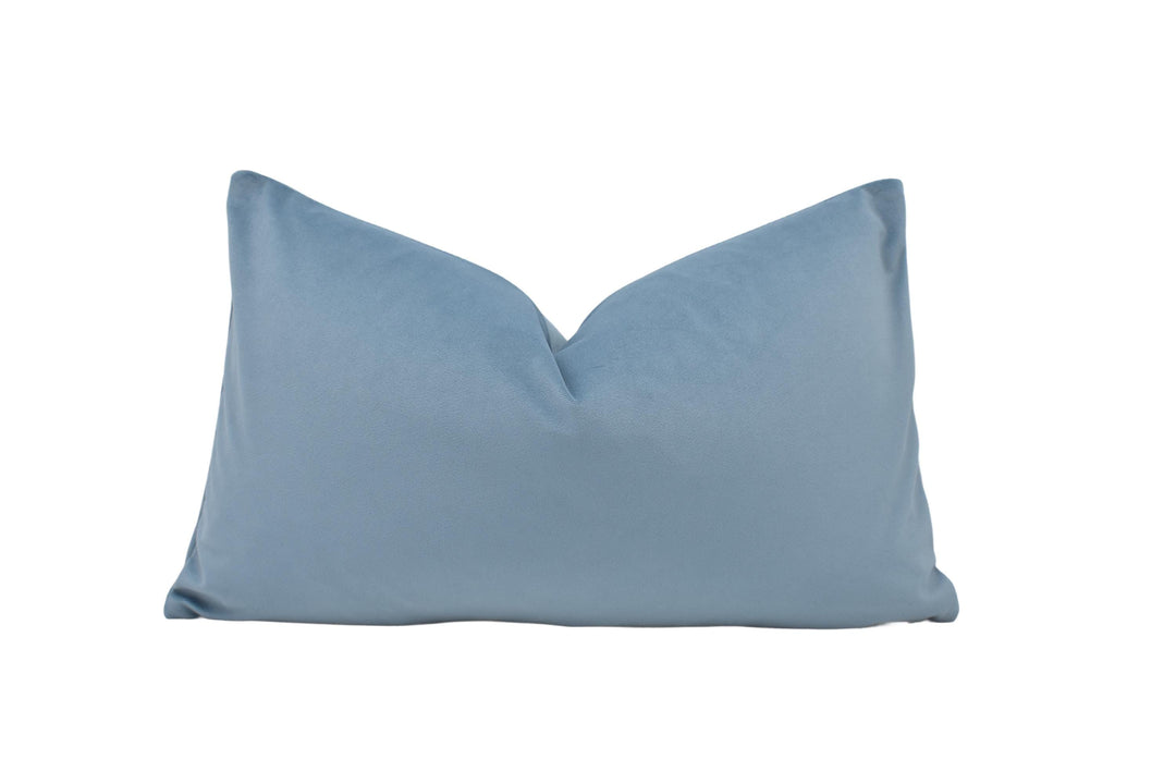 a blue pillow on a white background