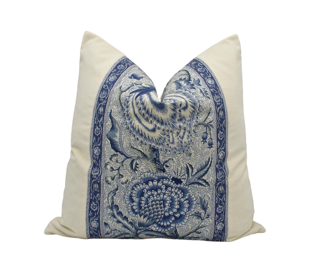 A decorative pillow with a blue and white floral pattern.