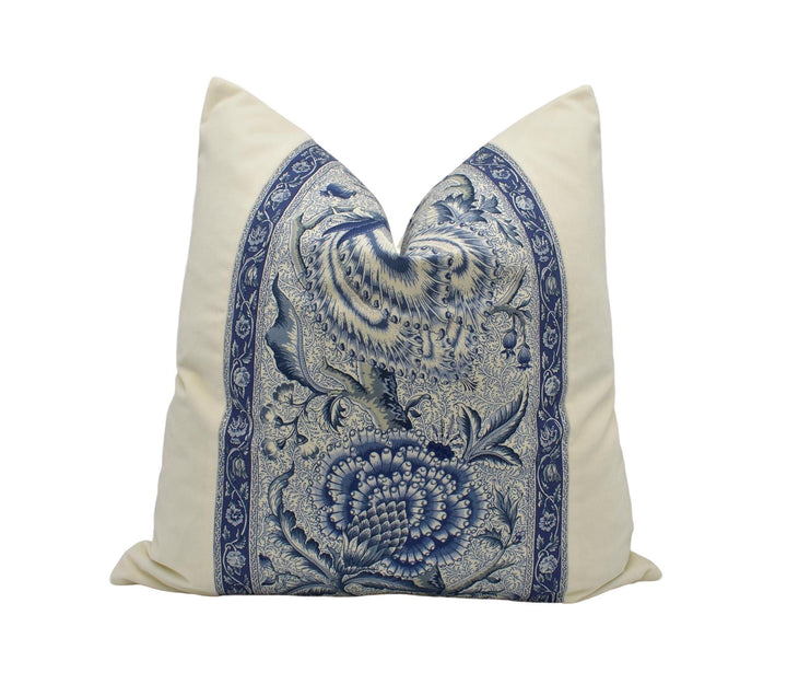 A decorative pillow with a blue and white floral pattern.