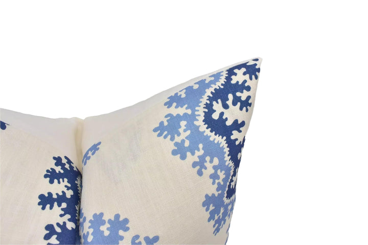 a close-up view of a decorative pillow with a blue and white floral pattern.