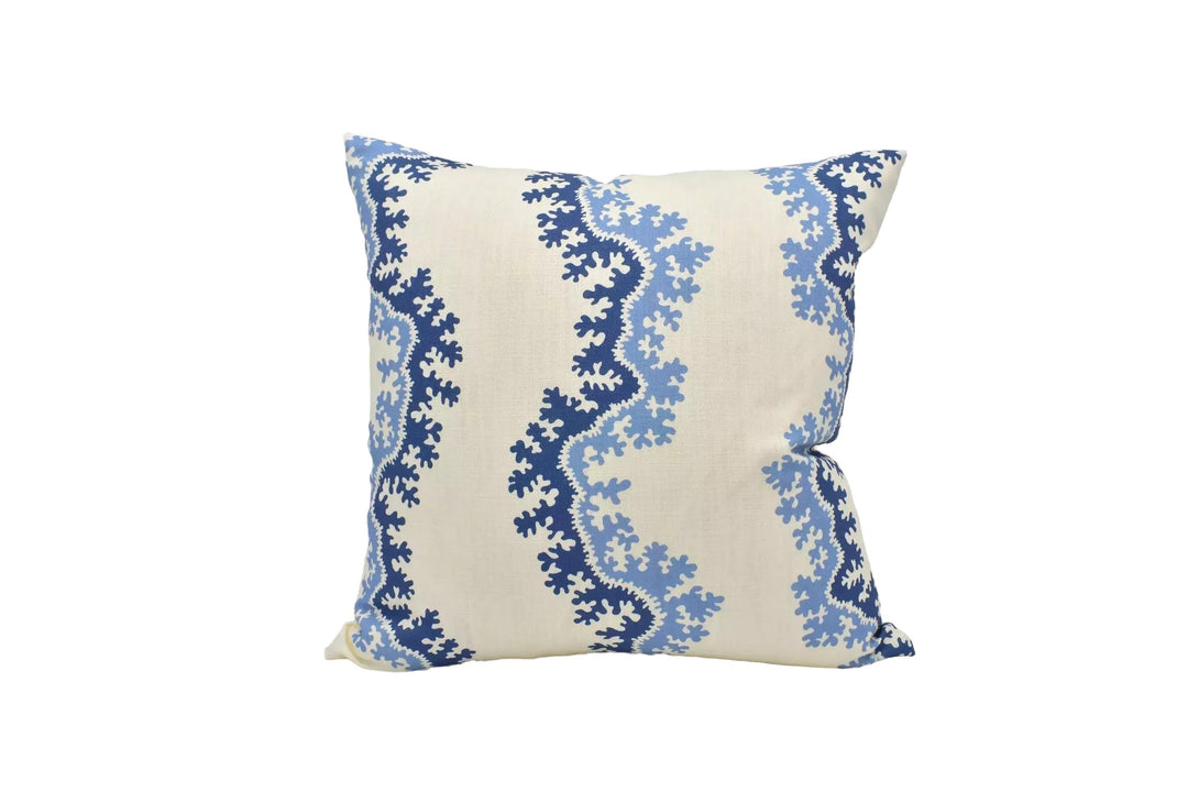 A decorative throw pillow with a blue and white floral pattern is displayed against a white background.