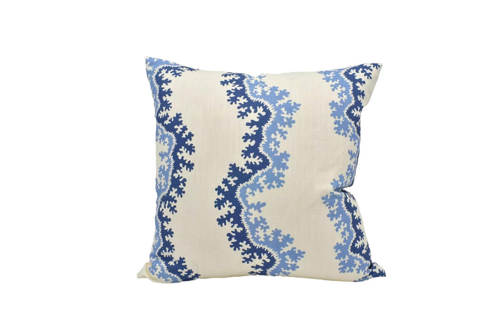 A decorative throw pillow with a blue and white floral pattern is displayed against a white background.