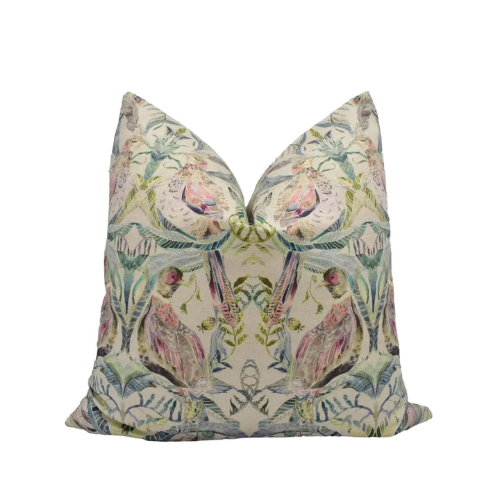 a decorative pillow with a repeating pattern of birds and leaves in various colors, including pink, green, and blue.