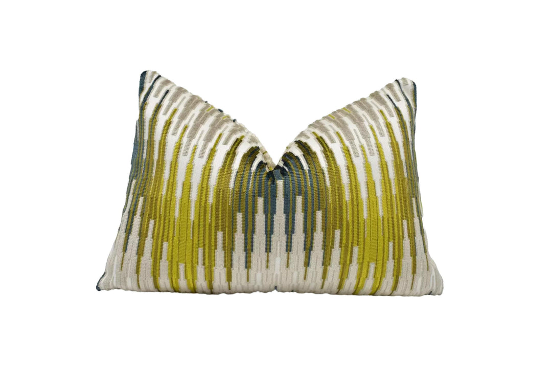 a decorative pillow with a striped pattern in shades of green and white.