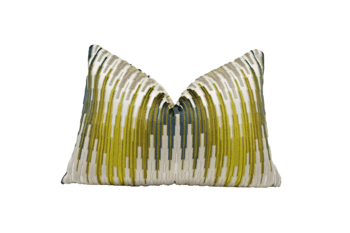 a decorative pillow with a striped pattern in shades of green and white.