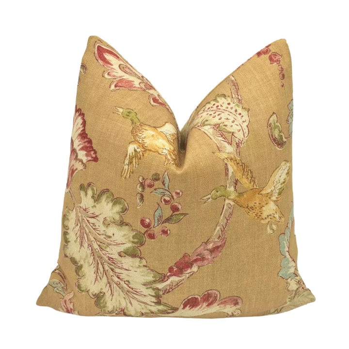 A decorative pillow with a floral pattern in shades of yellow and red.