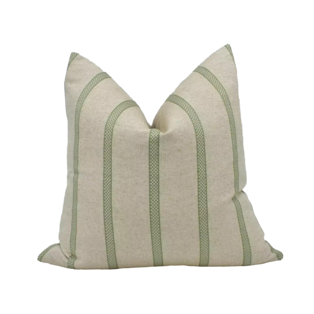 A beige pillow with green stripes, sitting against a white background.