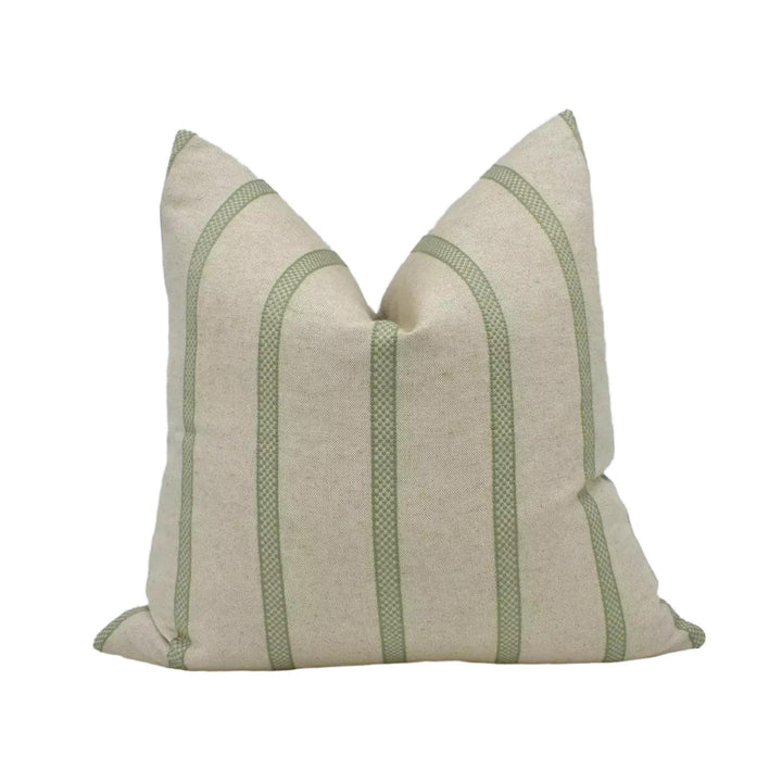 A beige pillow with green stripes, sitting against a white background.