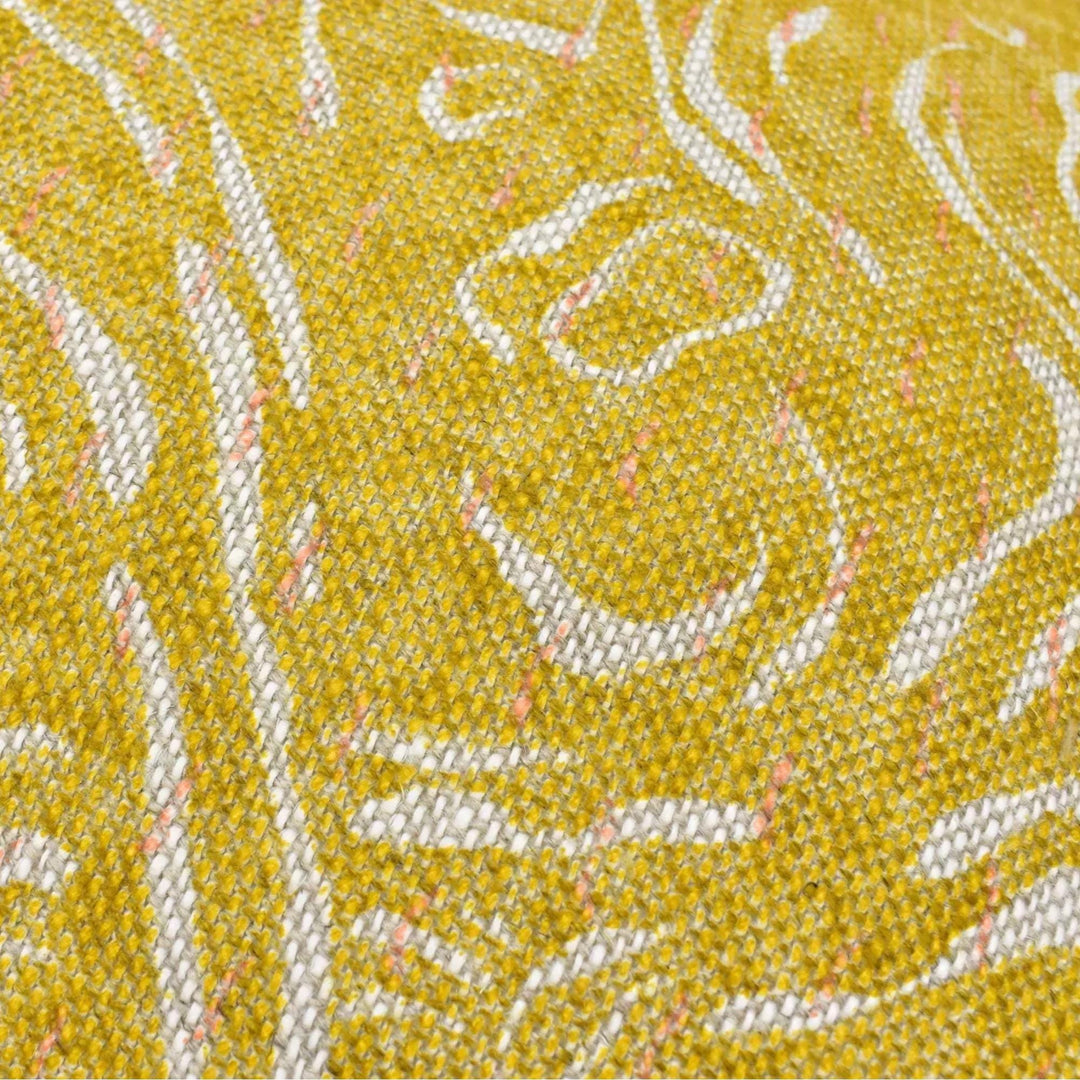 a close-up view of a textured fabric with a yellow and white pattern.