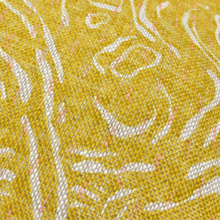 a close-up view of a textured fabric with a yellow and white pattern.