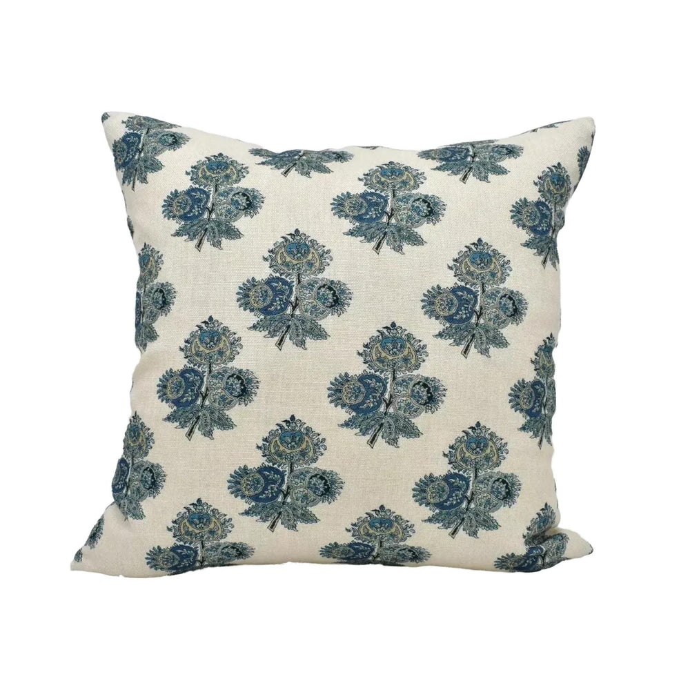 A square throw pillow with a repeating floral pattern in shades of blue and green.