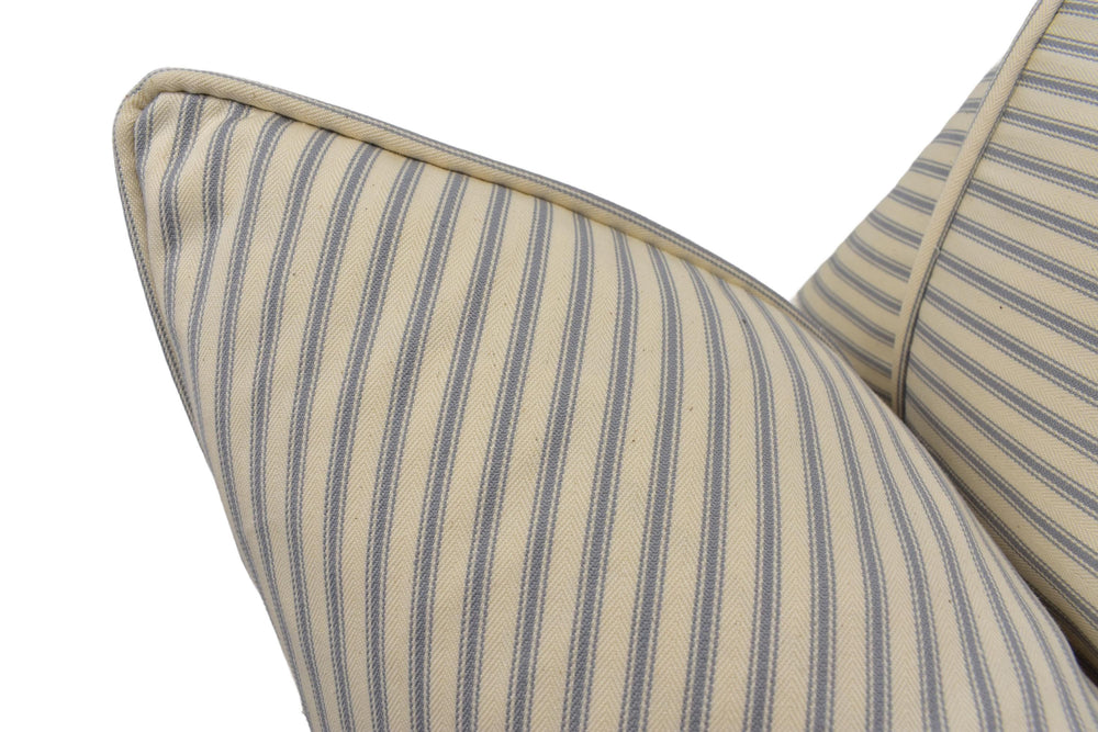 a close up of a striped pillow on a chair
