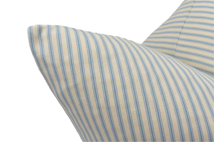 A close-up view of a striped pillow with a blue and white pattern.