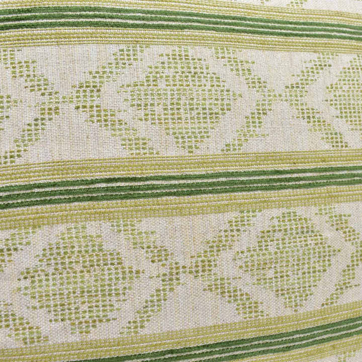 a close-up view of a fabric with a repeating pattern of green and white stripes. The pattern appears to be a geometric design, with a diamond shape and a floral motif. The fabric has a textured appearance, suggesting it could be a type of textile or upholstery material.
