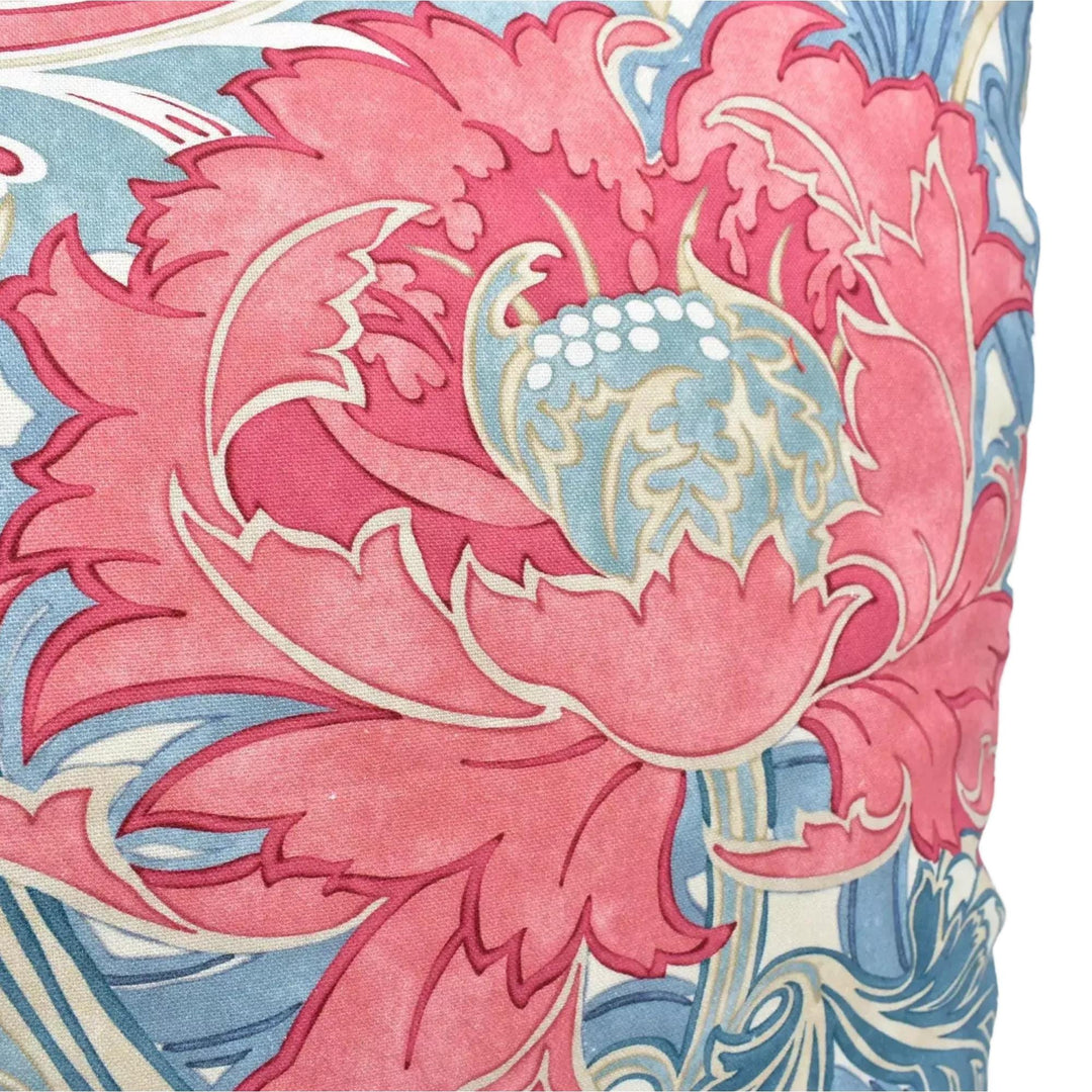 a close-up view of a vibrant, colorful floral pattern with a large pink flower at the center. The pattern is composed of various shades of blue and pink, creating a visually striking and intricate design.