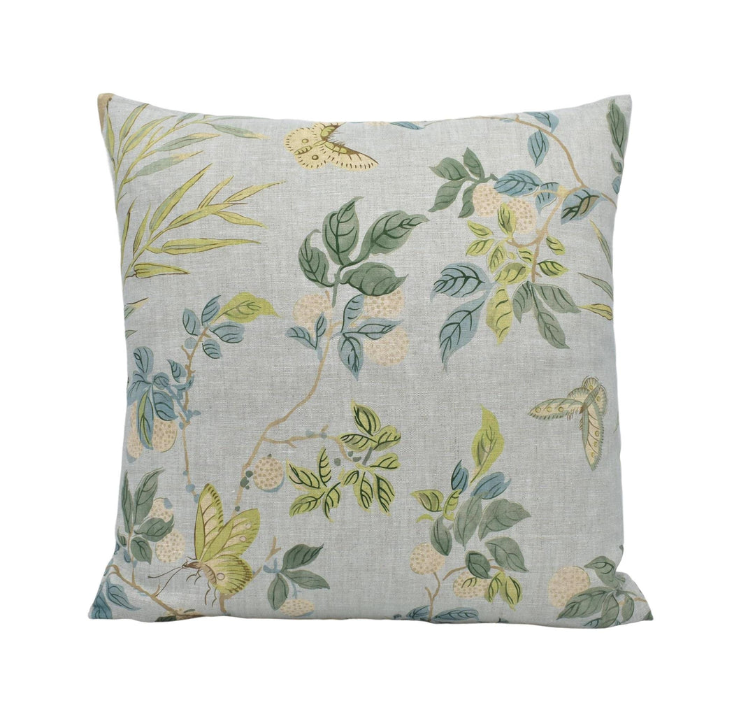a white pillow with a green and yellow floral pattern