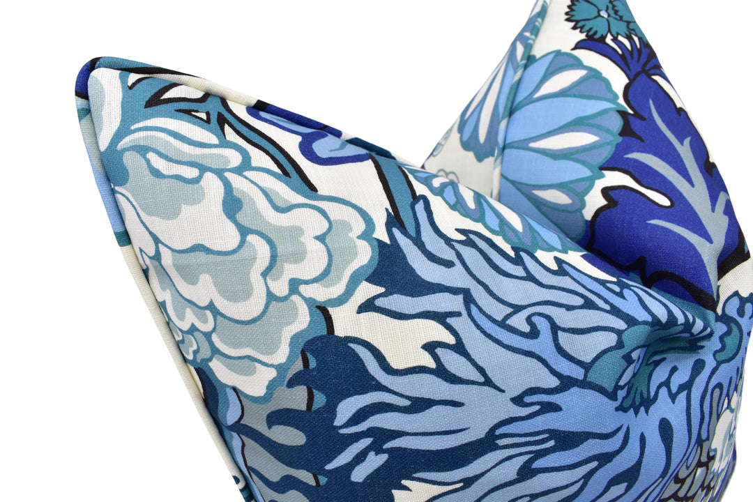 a close up of a blue and white pillow on a white background
