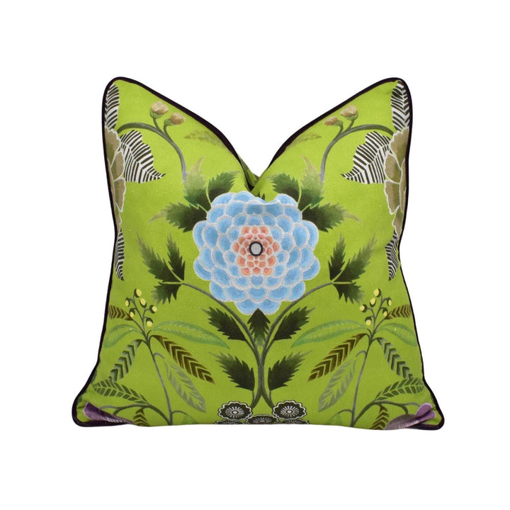 a green pillow with a blue flower on it