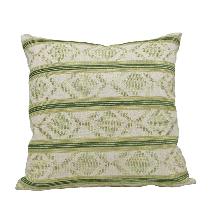 A square throw pillow with a repeating pattern of green and white diamond shapes.