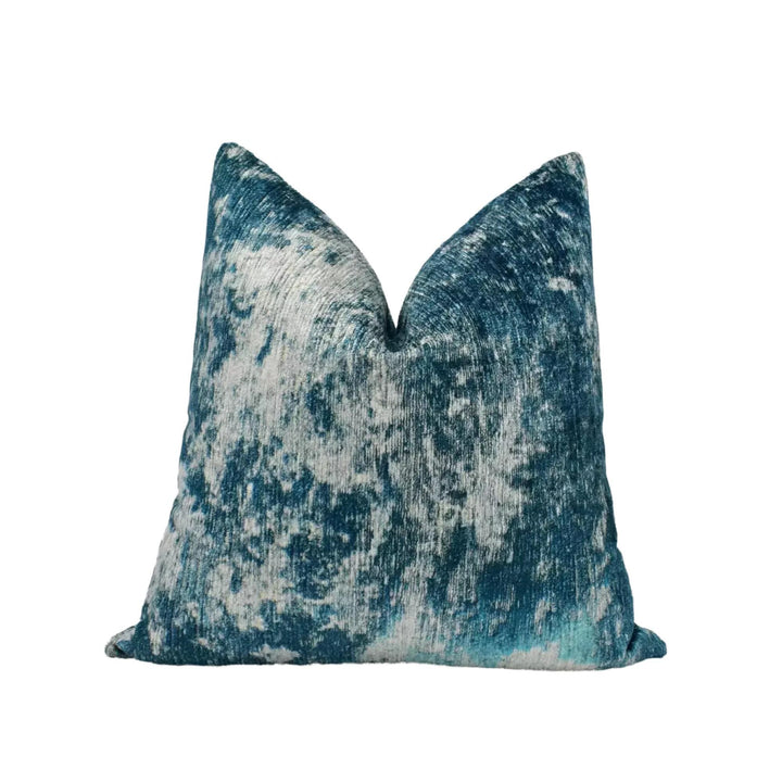 A blue and white textured throw pillow is shown against a white background.