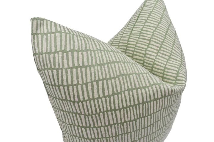 A close-up image of a green and white patterned pillow.