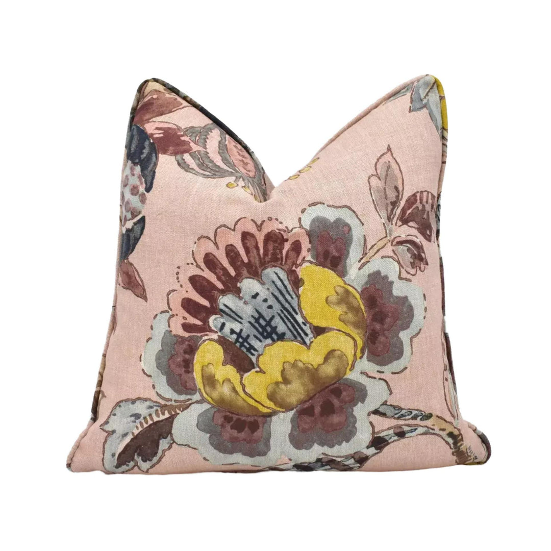 A pink and yellow floral print pillow with a decorative design.