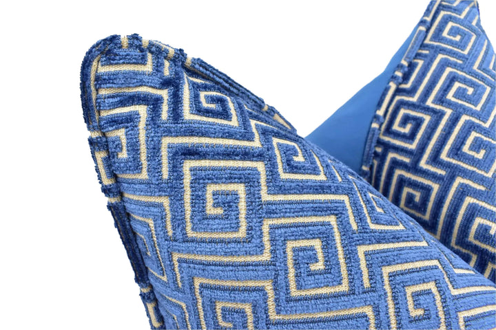 a close-up view of a blue and gold patterned pillow, with the pillow&
