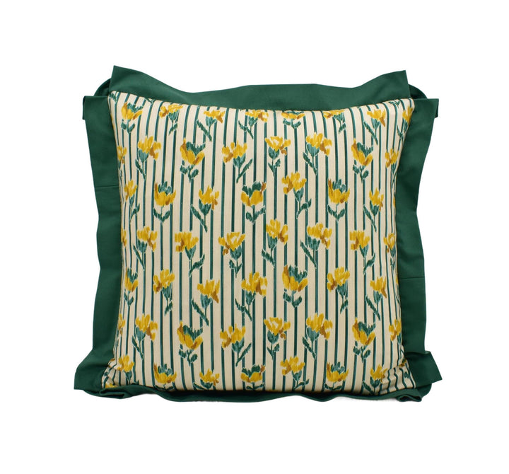 A square throw pillow with a floral pattern in shades of green and yellow.
